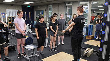 Trainer teaching in a gym