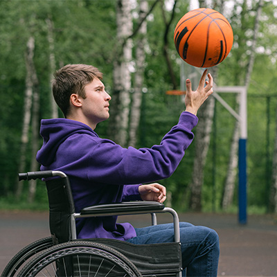 Person in wheelchair spinning basketball