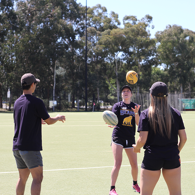 Three people throwing a touch ball